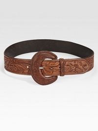 An oversized buckle and intricately designed leather give this belt rustic charm. About 2 wideLeatherImported