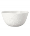 An elegant white-on-white pattern featuring an embossed vine motif and interior glaze lends the Opal Innocence Carved fruit bowl to refined dining every day.