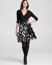 A study in contrasts, this DKNY systems dress goes bold in black and white. A solid top flaunts a flattering faux-wrap silhouette, while a flared skirt stuns with an abstract print.