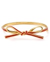 Take a bow. This delicate gold-plated bangle wraps the wrist in kate spade new york style.