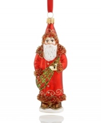 Gilded in a Gaelic sash of red and green, this glass ornament from Vaillancourt offers a historic take on the lovable gift-giving Santa Clause of present day. Delicately crafted with beaded and sparkling details for a brilliant addition to any Christmas tree.