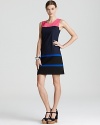 Vibrant stripes interrupt the sleek navy silhouette of this DKNY shift dress for vivid alternative to the classic LBD.