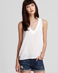 Refresh your whites with an Aqua tank rendered is a flowing silhouette with a deep v neck. Paired with short denim cutoffs or staple LBPs, the look is clean and crisp all summer long.