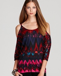 A vibrant tribal-inspired print enriches this breezy, cold shoulder top with color and depthfor fall.