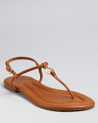 Simply the essence of chic, easy summer style, these slim-strapped flats are equally at home on city streets and sandy beaches. By Tory Burch.