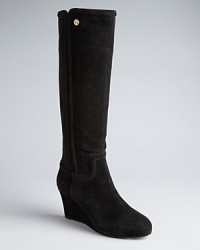 Tory Burch will take you places in these tall wedge boots embellished with subtle yet eye-catching logo details.