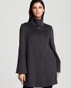 A feminine A-line silhouette lends a ladylike look to Armani's virgin wool coat--horizontal seaming details lend a modern look.