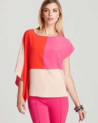 On-trend color block details and stylish asymmetric sleeves invigorate this vibrant silk Trina Turk top with the spirit of the new season.