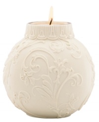 Embossed holly and scroll designs embellish this votive candle holder, perfect for adding a glow to your holiday table. From Lenox.