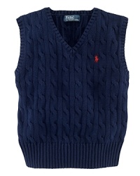 The essential sweater vest is a handsome layer rendered in durable cable-knit cotton.