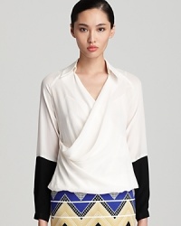 Make a bold statement in this chic, color blocked Trina Turk blouse that flaunts a flattering faux wrap topin pure silk.