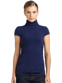 THE LOOKLuxe 2-ply cashmere from expertly maintained inner Mongolian cashmere goatsFeatures long, fine, smooth fibers top-dyed for maximum color saturationTurtleneck with ruched back detailRibbed cuff cap sleevesRuched sides Ribbed hemTHE FITAbout 23 from shoulder to hemTHE MATERIALCashmereCARE & ORIGINDry cleanImportedModel shown is 5'10 (177cm) wearing US size Small. 