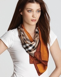 Classic camel check print and a buckle printed border accent this luxurious square silk scarf from Burberry.