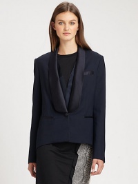 A modern variation on the traditional tuxedo, with feminine touches including an extended satin collar