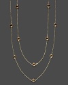 Eighteen faceted citrine stations sparkle in a long, loopable 14K yellow gold chain.