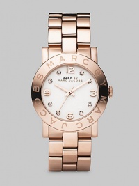 A glowing and sparkling timepiece with a polished IP rose gold finish over stainless steel and a bold link bracelet. Precision quartz movement Water-resistant to 3ATM Signature bezel Round stainless steel case; 36mm diameter (1.42) White dial Arabic numerals and rhinestone hour markers Second hand Link bracelet; 20mm wide (.79) Imported 