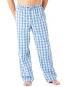 Prepare for a comfortable snooze cruise in these soft cotton pajama pants, featuring a cool check pattern that looks great with a mug full of coffee and the Sunday paper.