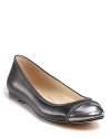 Gleaming and glittering, these chain-decked flats feature a metallic captoe and loads of attitude. By KORS Michael Kors.