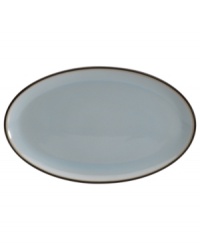 Handsome and understated, the Sienna oval platter features a glazed blue tint and mocha trim for smart-casual style with every entree.