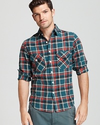 Whether you're grabbing a cheeseburger at the diner or catching the latest horror flick downtown, this cool plaid button-down spruces up your attire.