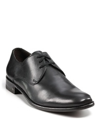 This handsome dress shoe plays the field with more pronounced stitching details and a peace sign logo at the side heel.