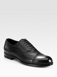 Handsome leather oxford with impeccable hand stitching and painting, exuding expert Italian craftsmanship and attention to detail.Leather upperLeather liningPadded insoleRubber soleMade in Italy