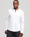 A knit construction lends a unique feel to a classic fit sport shirt from Michael Kors.