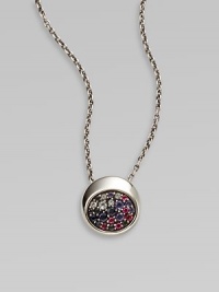 From the Eclipse Collection. A chunky round disc paved with an array of faceted gemstones sits within a sleek setting of polished sterling silver on a silver chain.Blue sapphires, sky blue topaz, iolite and rhodoliteSterling silverChain length, adjusts from about 16-18Pendant diameter, about ½Lobster claspImported