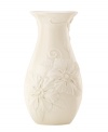 Teeming with fresh blooms, the Floral Fields vase from Lenox exudes a serene, understated elegance. A simple silhouette in creamy ivory porcelain balances elaborate sculpted detail.