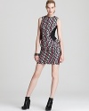 Rock downtown cool in this Milly mini dress, boasting a bold zigzag print juxtaposed against solid side panels with ruffle peplums. An exposed back zipper continues the edgy look, perfectly punctuated with wedge booties and an armful of metallic bangles.