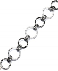 Elevate your ensemble with simple accessories. This trendy bracelet by Alfani features a playful interlocking circle design crafted in silver tone and hematite tone mixed metal. Approximate length: 7-3/4 inches.