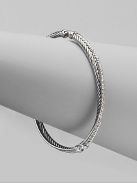 From the Silver Ice Crossover Collection. A twisted cable crisscrosses a diamond band in this graceful bangle of sterling silver and 14k white gold. Diamonds, 0.49 tcw Sterling silver and 14k white gold Diameter, about 2¼ Made in USA