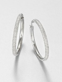 From the Brilliance Collection. The design is simple but the look is shimmering in these slender hoops set with rows of dazzling rhinestones.GlassSilvertoneDiameter, about 1.25PiercedImported