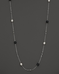 This sterling silver necklace, gleaming with blue tigers eye and freshwater pearls, makes an elegant statement. By Di MODOLO.