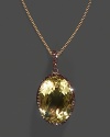 A lemon quartz pendant accented with brown diamonds on a yellow gold chain.