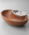 Serve casual snacks with the Dharma chip and dip, a modern beauty balancing carved wood and gleaming Nambé metal. Exterior and inset bowls share a sleek, oval silhouette and askew rims to showcase the delicious foods within. Coordinates with Dharma bowls and trays, also by Neil Cohen.