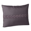 A lush, contrasting grosgrain ribbon, folded into textural squares, adds detail to this silk decorative pillow.