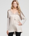 Soft knit sleeves enrich this silk Vince top for a beautiful contrast--its flowy drape paired atop skinny jeans lends for a stylish variation in silhouettes.