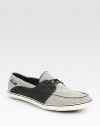 Two-tone, cotton canvas upper adds a contemporary touch to a casual classic.Cotton canvas upperPadded insoleRubber soleImported