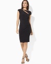 A flattering matte jersey dress is modernized with a glistening broach at the shoulder and a cutout neckline.