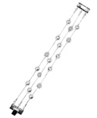 Strand together your perfect look with AK Anne Klein's flaunt-worthy flex bracelet. Crafted in imitation rhodium-plated mixed metal, it's adorned with glass pearls and crystal pave ball accents. Approximate length: 7-1/2 inches.