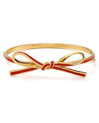 Take a bow. This delicate gold-plated bangle wraps the wrist in kate spade new york style.