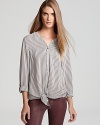 Slim, hypnotic stripes add texture and definition to this elegant Joie blouse, rendered in pure silk.