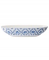 Vintage charm meets modern durability in the Farmhouse Touch oval bowl, featuring cornflower-blue laurels and blooms in premium porcelain from Villeroy & Boch.