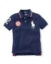 A preppy short-sleeved polo shirt in breathable cotton mesh is accented with London embroidery and a US Olympic Team embroidered emblem, celebrating Team USA's participation in the 2012 Olympics.