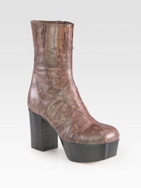 Add some exotic flair with this reptile-embossed leather silhouette on a tall stacked platform and heel. Stacked heel, 3¾ (95mm)Stacked platform, 1¾ (45mm)Compares to a 2 heel (50mm)Embossed leather upperSide zipLeather lining and solePadded insoleMade in ItalyThis style runs small. We recommend ordering one half size up for a standard fit. 