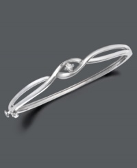 Simplicity and style twisted into one. Bangle by Wrapped in Love™ features two bands of sterling silver sweeping past one another with a glittering round-cut diamond (1/10 ct. t.w.) at their intersection. Approximate width: 2-3/8 inches.