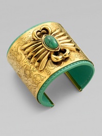 A striking relief design with a colorful turquoise stone is the centerpiece of a wide, delicately etched golden cuff layered over a bright leather interior.TurquoiseLeatherGoldplatedDiameter, about 2¼Width, about 2Made in France