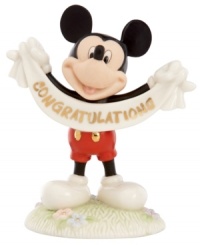 A cute memento of a major accomplishment, Mickey Mouse extends his congratulations with a gold-lettered banner in this fine china Disney figurine by Lenox.