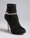 Slim, snake-embossed ankle straps and heels define these black booties by IVANKA TRUMP. Dressed enough for the office and evenings out, they are a versatile must-have.